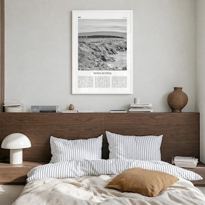 Nova Scotia Poster, black and white photo print in a white wood frame, hanging in a bedroom