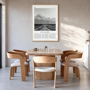 New Zealand Poster, black and white photo print in a natural wood frame, hanging in a dining room