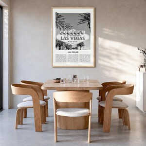 Las Vegas Poster, black and white palm photo print in a natural wood frame, hanging in a dining room