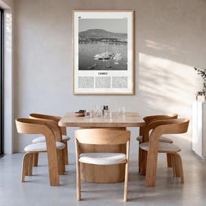 Corfu Poster, black and white photo print in a natural wood frame, hanging in a dining room