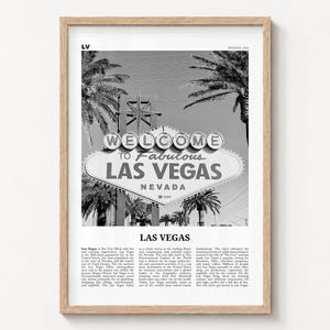 Las Vegas black and white poster print in a natural wood frame on a wall