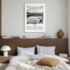Oregon Poster, black and white lake photo print in a white wood frame, hanging in a bedroom
