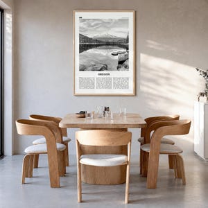 Oregon Poster, black and white lake photo print in a natural wood frame, hanging in a dining room