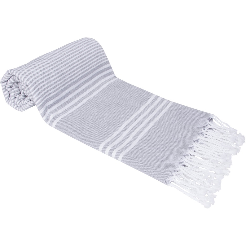 May include: A gray and white striped beach towel with white fringe. The towel is rolled up on one end.