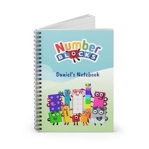 May include: A blue and green spiral notebook with the words "Number Blocks" in a colorful font. The notebook has a picture of the Number Blocks characters and the text "Daniel's Notebook".