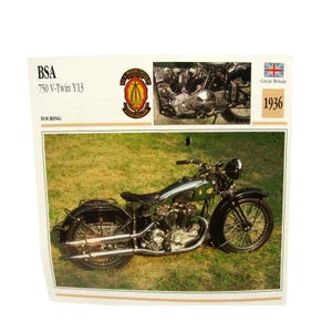 May include: A vintage BSA 750 V-Twin Y13 motorcycle from 1936, in a green and black color scheme, is displayed on a grassy field. The image includes the BSA logo, a small engine detail, and the Union Jack flag.