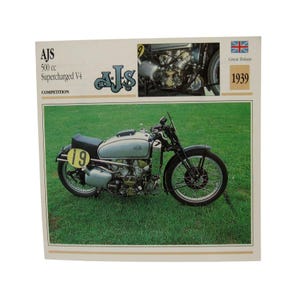 May include: A vintage AJS 500 cc Supercharged V4 competition motorcycle with a silver fuel tank, black seat, and a yellow number 19 plate. The print includes the text AJS 500 cc Supercharged V4, Great Britain, and 1939, with an engine detail.