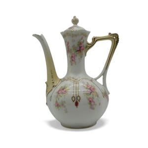 May include: Antique white porcelain pitcher with a long spout and handle. The pitcher is decorated with pink roses and gold accents. A small lid sits on top. The pitcher is a vintage piece.
