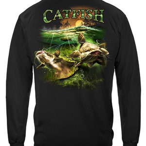 May include: Black long-sleeve t-shirt with a graphic print of two catfish swimming in a green and blue underwater scene. The text "CATFISH" is printed in white on the back of the shirt.