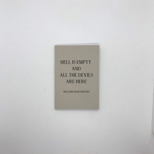 Puede incluir: Una tarjeta rectangular gris claro con la cita "HELL IS EMPTY AND ALL THE DEVILS ARE HERE" en texto negro. El nombre del autor, William Shakespeare, está impreso debajo. Sobre un fondo blanco.