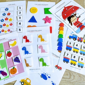 Puede incluir: Un conjunto de hojas de actividades educativas imprimibles para ni&ntilde;os. Las hojas presentan ilustraciones coloridas y actividades como contar, hacer coincidir formas y colores, ordenar y resolver rompecabezas. El texto en las hojas incluye "Puedo contar", "Puedo hacer coincidir las formas", "Puedo hacer coincidir los colores", "Puedo ordenar", "Puedo resolver el rompecabezas" y "N&uacute;meros".