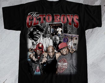 May include: Black t-shirt with a vintage-style graphic of the Geto Boys rap group. The graphic features the group members in a collage style with the words "The Geto Boys" in red and white lettering.