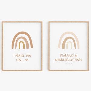 May include: Two framed prints with rainbow designs and inspirational quotes. The first print features a rainbow in shades of brown and gold with the text "I praise you for I am". The second print features a rainbow in shades of pink and brown with the text "Fearfully & Wonderfully Made Psalm 139:14".