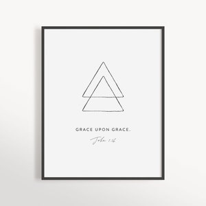 May include: Black and white minimalist print featuring two overlapping triangles and the text "GRACE UPON GRACE. John 1:16".