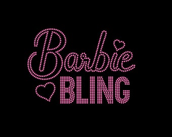 May include: Pink rhinestone design that reads "Barbie BLING" with a small heart before the word "BLING".