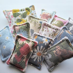 May include: A collection of 10 colorful floral patterned dishcloths with a mesh texture. The dishcloths are made of a soft, absorbent material and are perfect for cleaning up spills and messes in the kitchen.