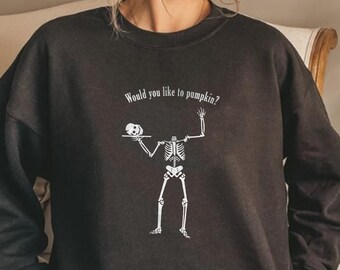 May include: Black sweatshirt with a white skeleton holding a pumpkin and the text "Would you like to pumpkin?"