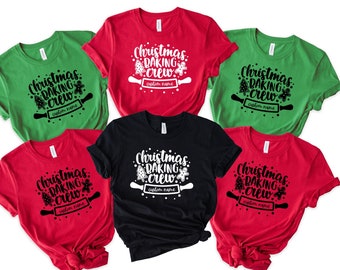 May include: Five Christmas baking crew t-shirts in red, green, and black. The shirts feature a white graphic with the text "Christmas Baking Crew" and a rolling pin with a gingerbread man and Christmas trees.