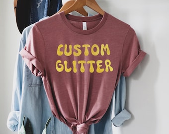 カスタムグリッターTシャツ、パーソナライズグリッターTシャツ、カスタムグリッターTシャツ、カスタムグリッターテキスト、キラキラTシャツ、クリスマスグリッターTシャツ、