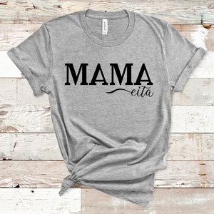 May include: Gray t-shirt with the text "MAMA eita" printed in black.