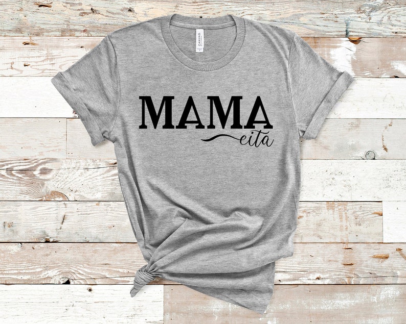 May include: Gray t-shirt with the text "MAMA eita" printed in black.