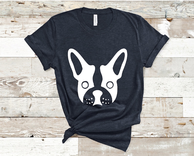 May include: A dark blue t-shirt with a white silhouette of a French bulldog's face.