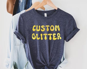 カスタムグリッターTシャツ、パーソナライズグリッターTシャツ、カスタムグリッターTシャツ、カスタムグリッターテキスト、キラキラTシャツ、クリスマスグリッターTシャツ、