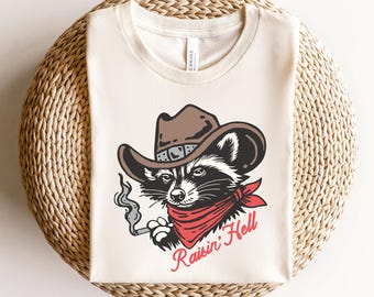 レイジン・ヘル フェラルTシャツ、エッジの効いたグラフィックTシャツ、パンクロックステートメントシャツ、大胆なステートメントTシャツ、フェラルバイブス、大胆なグラフィックプリントTシャツ