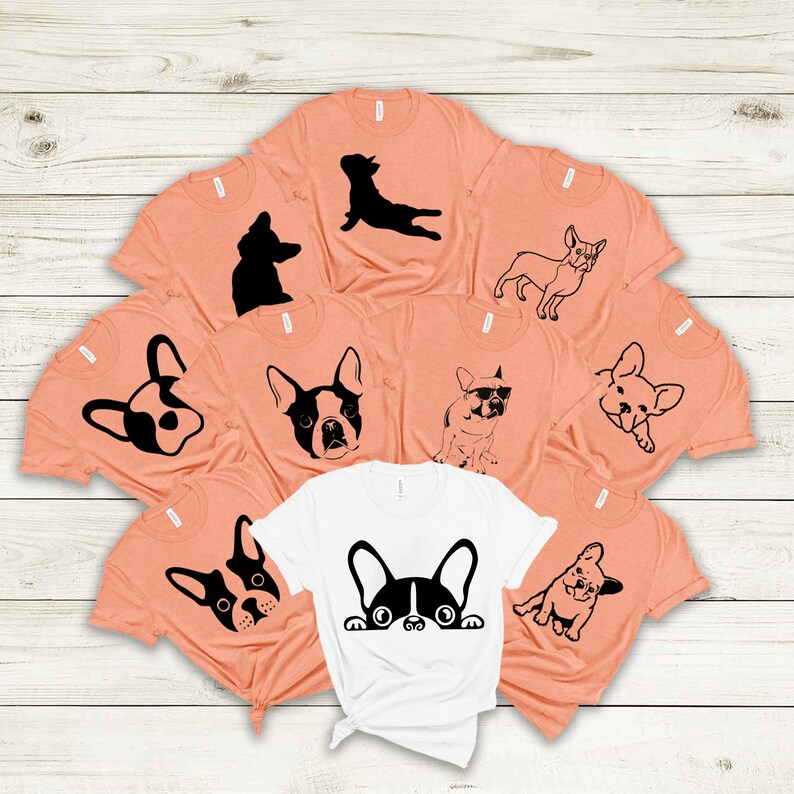 May include: Set of nine peach-colored t-shirts with black French bulldog silhouettes. The shirts feature various poses of the dog, including sitting, standing, and laying down. One shirt is white with a black French bulldog peeking out from behind the collar.