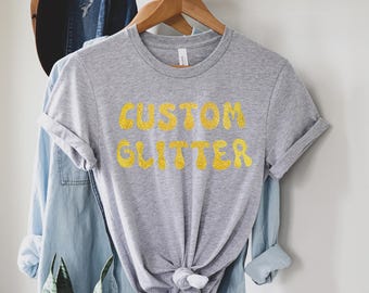 カスタムグリッターTシャツ、パーソナライズグリッターTシャツ、カスタムグリッターTシャツ、カスタムグリッターテキスト、キラキラTシャツ、クリスマスグリッターTシャツ、