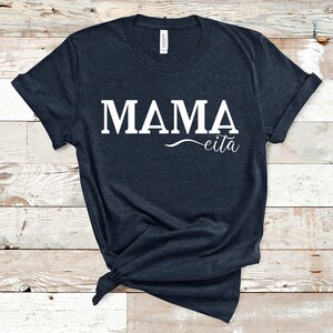 May include: A dark blue t-shirt with the text "MAMA eita" printed in white.