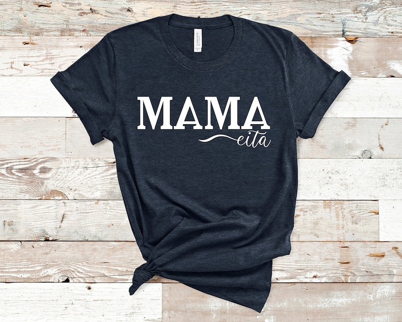 May include: A dark blue t-shirt with the text "MAMA eita" printed in white.
