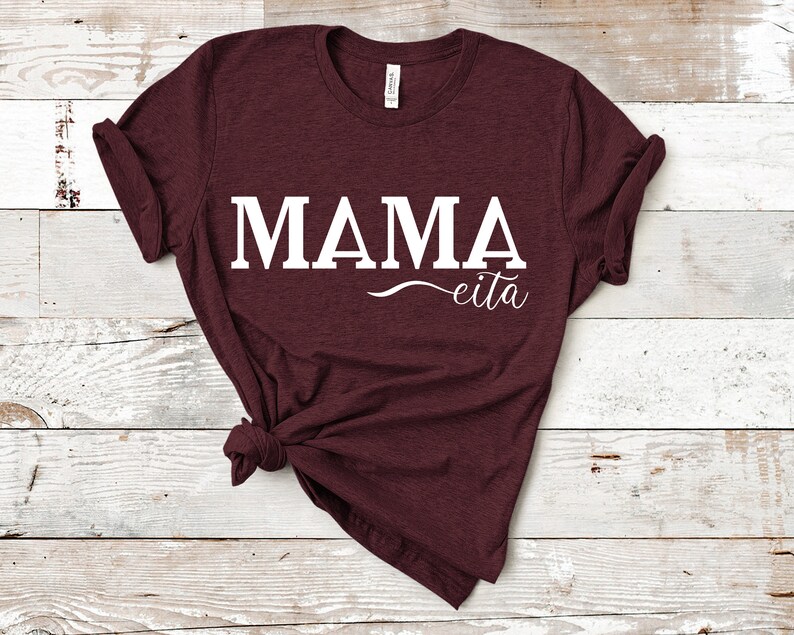 May include: A maroon t-shirt with the text "MAMA eita" printed in white.