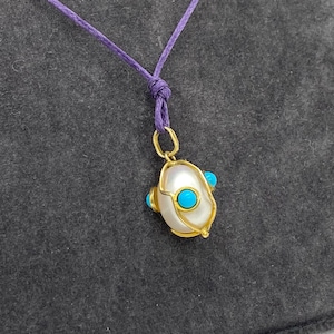 Pearl egg charm with turquoise on silver 925o frame set in a long cord. Spring/ Easter egg necklace with natural gemstones, made in Greece.
