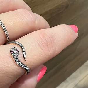 18k rose gold snake ring covered on top with natural champagne diamonds & rubies. Birthday jewellery gift symbolising renewal and purity.