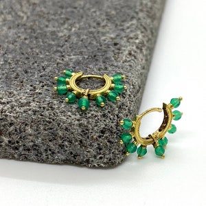 18 carats gold small hoops surrounded by natural green onyx. Elegant easy-to-wear solid gold earrings with May&#39;s birthstone green onyx.