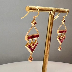 18k rose gold V - shaped long earrings with 32 square natural rubies. Glamorous Valentine’s gift  expressing passion and raw feelings.