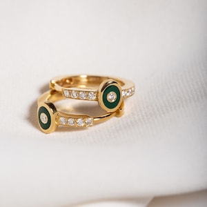 Eye design 18k yellow gold small hoops with diamonds and round green enamel design. MELIGreece's easy-to-wear yellow gold diamond earrings.