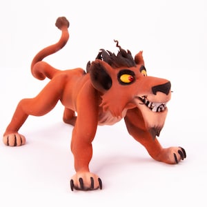 May include: A red and black lion figurine with a menacing expression. The lion has sharp teeth and claws, and its eyes are bright yellow. The figurine is made of a soft, pliable material, possibly clay or polymer clay.