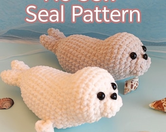 May include: Two plush seal toys, one cream-colored and one light brown, are displayed on a light blue surface with seashells. The text "No Sew Seal Pattern" is written in pink and white at the top of the image.