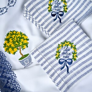 Custom order - tablecloth and blue and white striped linen napkins with embroidered lemon wreaths and the text "La dolce vita".