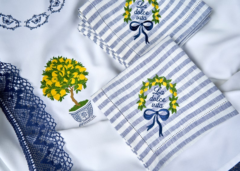 Custom order - tablecloth and blue and white striped linen napkins with embroidered lemon wreaths and the text "La dolce vita".