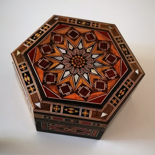 Exclusive jewelry box hexagonal with rich inlays made of mother-of-pearl buy and fine woods.