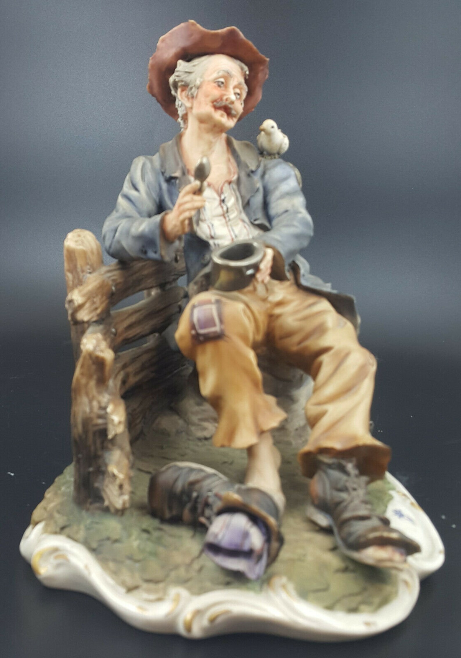 capodimonte tramp on bench with dog