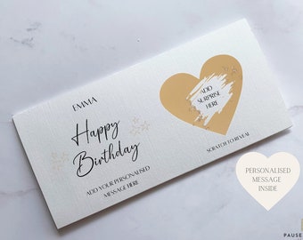 May include: A white card with a gold heart and the text "Happy Birthday" and "Emma". The heart has a gold scratch-off area with the text "Add Surprise Here" and "Scratch to Reveal". The card also has a personalized message inside.
