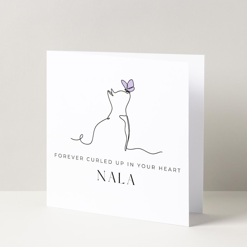 May include: A white card with a line drawing of a cat looking up at a purple butterfly. The text "FOREVER CURLED UP IN YOUR HEART NALA" is below the drawing.