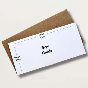 May include: A white size guide card with black text, labeled "Size Guide", sits atop a brown envelope. The card's dimensions are labeled: width 21cm, height 9.9cm. The background is a soft, neutral color.
