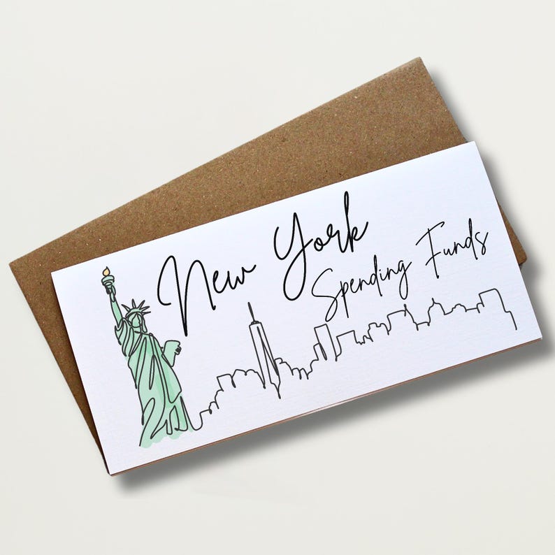 May include: A white card with the text "New York Spending Funds" in black script, featuring a green Statue of Liberty and a black skyline. The card is placed on a brown envelope.