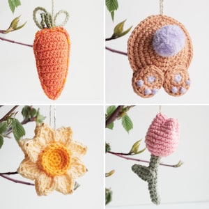 May include: Four crocheted Easter decorations hanging from branches. A carrot, a bunny, a daffodil, and a tulip.