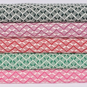 May include: Five fabric swatches featuring a geometric diamond pattern. The swatches are in shades of green, pink, red, and purple.